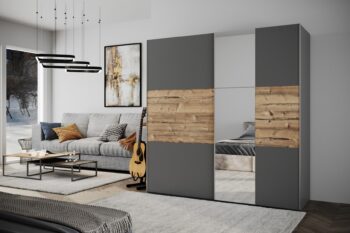 Moderná a zároveň praktická šatníková skriňa BASIA LUX s posuvnými dverami a efektne umiestneným zrkadlom.Skriňa disponuje veľkorysým úložným priestorom a Jej vnútro je účelne rozčlenené na časť s poličkami a časť s vešiakovými tyčami (viď. foto).Farebné prevedenie skrine je vo farbe grafit, spolu s detailom vo farbe alpský smrek.Nábytok je vyrobený z kvalitnej LTD dosky, ktorá je nenáročná na údržbu.Rozmery nábytku sú: (š/v/h) 200 x 215 x 65 cm.Dodávame v demontovanom stave.