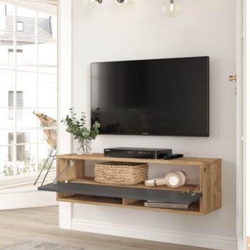 FREY 13: Elegantný stolík TV kombinujúci borovicu a šedú Hľadáte nábytok, ktorý by priniesol do vášho interiéru štýl a zároveň bol funkčný? FREY 13 je televízny stolík, ktorý spája moderný dizajn s praktickými prvkami. Tento stolík v kombinácii odtieňov borovice a šedej sa stane skvelým doplnkom pre vašu obývaciu izbu, kanceláriu či pracovňu.  Typ tovaru: stolík TV, dokonale doplní vaše moderné priestory.  Materiál: kvalitný a odolný LTD s hrúbkou 18 mm, zaručuje dlhú životnosť. Rozmery: 100 x 31,6 x 29,6 cm - ideálny rozmer pre rôzne veľkosti miestností. Farba: kombinácia prírodnej borovice a antracitu. Vybavenie: stolík ponúka plné dvierka (skrinka) a praktické odkladacie police. Štýl: moderné a dizajnové prevedenie, ktoré ocení každý milovník trendov.  Tvar: obdĺžnikový a rovný dizajn sa skvele hodí do každej miestnosti.  FREY 13 je viac než len televízny stolík. Je to spojenie funkčnosti a dizajnu, ktorý prinesie do vášho domova svieži a moderný vzhľad.
